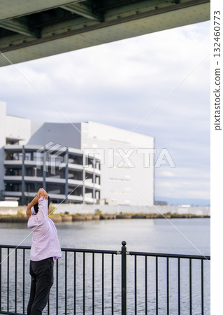 Man stretching with arms outstretched against the ocean background | Take a breather and refresh 132460773