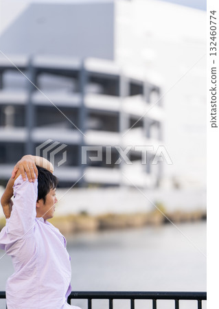Man stretching with arms outstretched against the ocean background | Take a breather and refresh 132460774