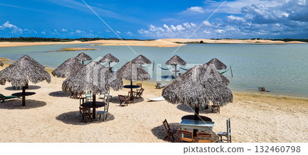 Straw huts on the banks of the Torta Lagoon, Tatajuba Beach at Jijoca de Jericoacoara, Ceara in Brazil 132460798