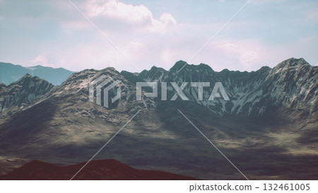 The rocky mountain range showcases snow covered peaks contrasting with the rocky slopes, set against a bright blue sky. A peaceful valley lies beneath, enhancing the natural beauty. The rocky mountain range showcases snow covered peaks contrasting with the rocky slopes, set against a bright blue sky. A peaceful valley lies beneath, enhancing the natural beauty. 132461005
