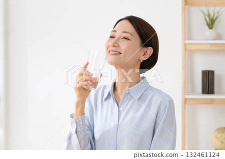 A woman drinking water 132461124