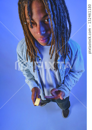 Young man holding gold bar promoting wealth Young man holding gold bar promoting wealth 132461180