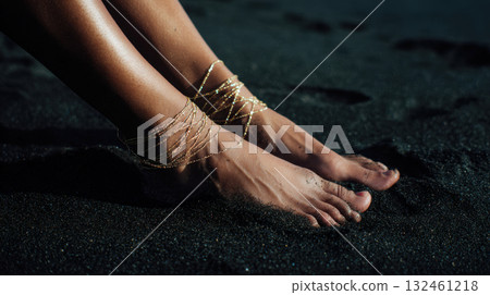 Gold-chained feet on beach 132461218