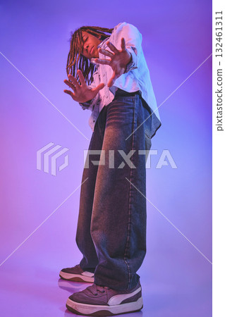 Young man dancing urban style vibrant neon light Young man dancing urban style vibrant neon light 132461311