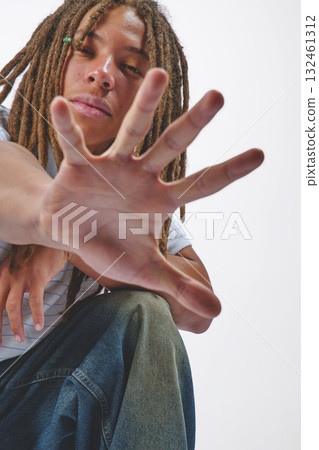 Young man extending hand reaching forward in studio 132461312