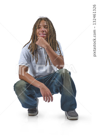 Young man with dreadlocks crouching, thinking on white Young man with dreadlocks crouching, thinking on white 132461326