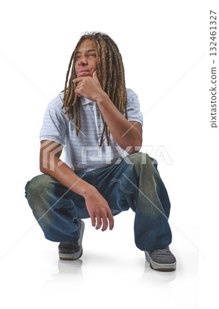 Young man with dreadlocks crouching, thinking on white Young man with dreadlocks crouching, thinking on white 132461327