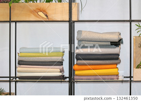 Wool sweaters on metal shelf 132461350