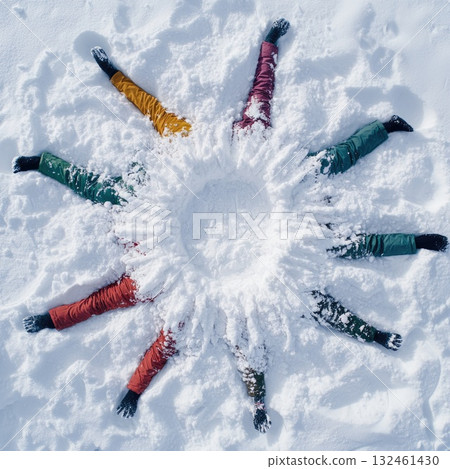 Faceless group of friends hiding in fresh snow. A joyful winter moment of fun and togetherness. 132461430