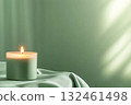 Single candle in a sleek minimalistic holder on a pastel table. A calm and elegant composition in soft light. 132461498