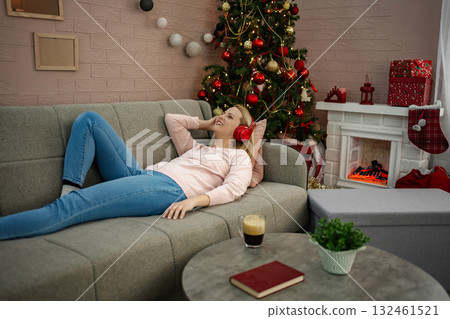 Relaxing at home with festive vibes and peaceful music during the holiday season Relaxing at home with festive vibes and peaceful music during the holiday season 132461521