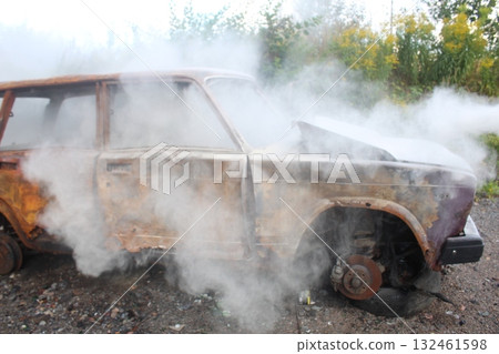 A car catches fire on the street. Fire and fire extinguishing in transport. Summer A car catches fire on the street. Fire and fire extinguishing in transport. Summer 132461598