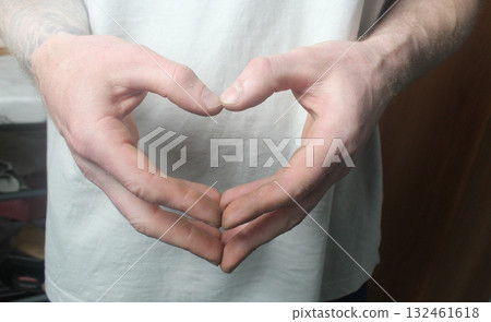 Men's hands are folded in a heart. Heart Symbol Men's hands are folded in a heart. Heart Symbol 132461618