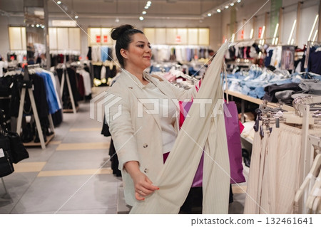 Exploring trendy fashion in a bustling clothing store 132461641