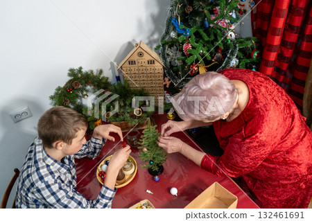 Grandmother and Grandson Decorating Christmas tree. Family together. Senior woman craft Grandmother and Grandson Decorating Christmas tree. Family together. Senior woman craft 132461691