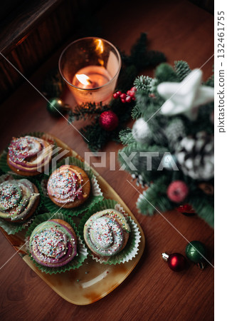 Christmas and New Year cupcakes on Christmas decorated table Christmas and New Year cupcakes on Christmas decorated table 132461755