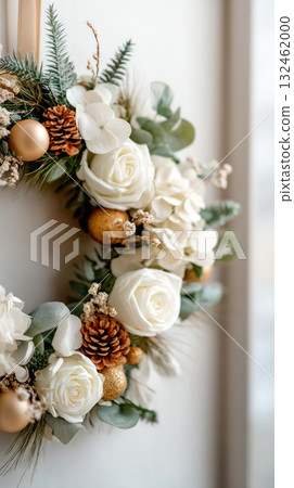 Elegant floral wreath featuring white roses, pinecones, and golden ornaments, perfect for seasonal decor and festive celebrations 132462000