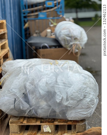 Pile of garbage bags sits on a wooden pallet 132462113