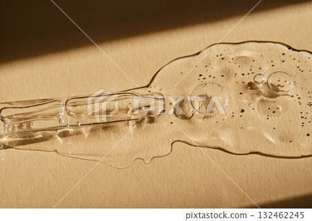 A pipette with cosmetic serum on a beige background. 132462245