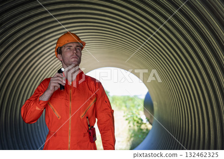 ndustry Engineers Walking Inside Circular water Pipe. Engineering or Worker inspection pipe  132462325