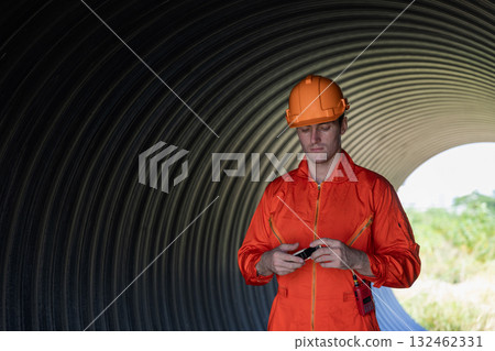 ndustry Engineers Walking Inside Circular water Pipe. Engineering or Worker inspection pipe ndustry Engineers Walking Inside Circular water Pipe. Engineering or Worker inspection pipe 132462331