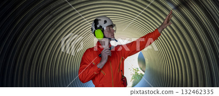 ndustry Engineers Walking Inside Circular water Pipe. Engineering or Worker inspection pipe  132462335