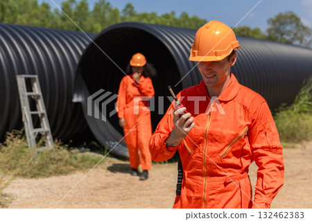 ndustry Engineers Walking Inside Circular water Pipe. Engineering or Worker inspection pipe  132462383