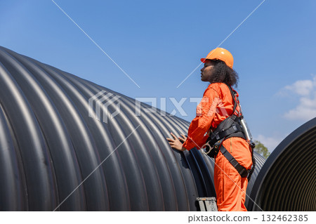 ndustry Engineers Walking Inside Circular water Pipe. Engineering or Worker inspection pipe  132462385
