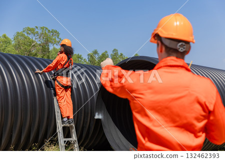 ndustry Engineers Walking Inside Circular water Pipe. Engineering or Worker inspection pipe ndustry Engineers Walking Inside Circular water Pipe. Engineering or Worker inspection pipe 132462393
