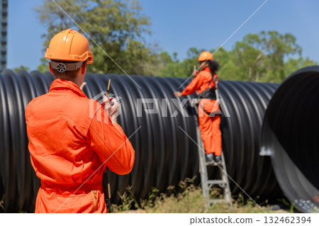 ndustry Engineers Walking Inside Circular water Pipe. Engineering or Worker inspection pipe ndustry Engineers Walking Inside Circular water Pipe. Engineering or Worker inspection pipe 132462394