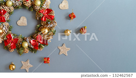A Christmas wreath on a dark gray background. Top view with space for text. A Christmas wreath on a dark gray background. Top view with space for text. 132462567