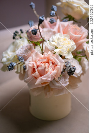 Spring bouquet of mixed flowers on vintage gray wall background behind 132462592