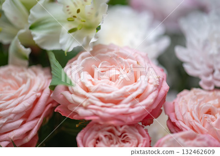 Spring bouquet of mixed flowers on vintage gray wall background behind 132462609