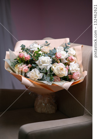 Spring bouquet of mixed flowers on vintage gray wall background behind 132462621