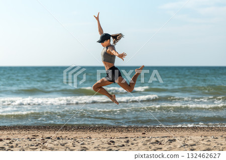 Energetic woman leaps at beach, Woman swiftly sprints and soars on sand, Woman rapidly runs and vaults with joy Energetic woman leaps at beach, Woman swiftly sprints and soars on sand, Woman rapidly runs and vaults with joy 132462627