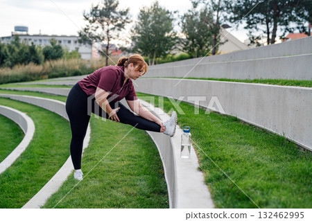 Body positive woman warming up before training. Body positive woman warming up before training. 132462995