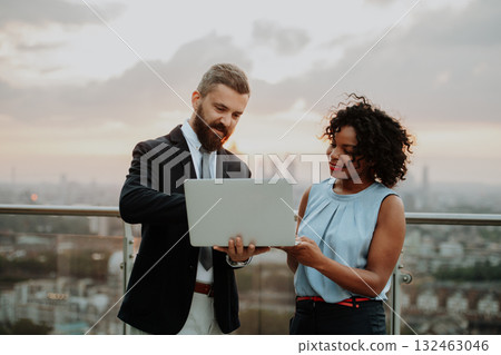 Two business people talking on the rooftop terrace of modern office Two business people talking on the rooftop terrace of modern office 132463046