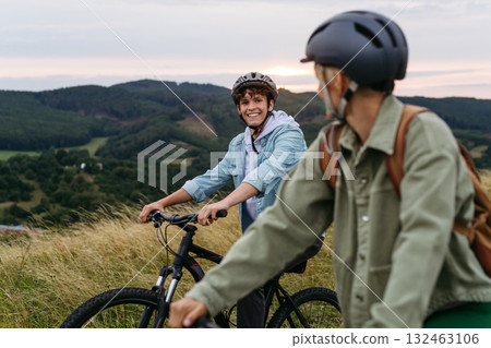 Mom and teen son on biking trip in nature. 132463106