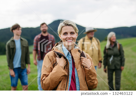 Portrait of beautiful woman during family hiking trip in nature. 132463122