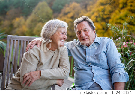 Peaceful moment for senior couple, enjoying warm autumn evening on terrace. Peaceful moment for senior couple, enjoying warm autumn evening on terrace. 132463154