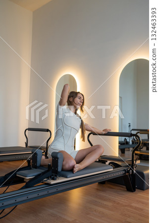 Woman doing mermaid exercise in a sunlite modern studio, embodying calm, focus, and strength. Woman doing mermaid exercise in a sunlite modern studio, embodying calm, focus, and strength. 132463393