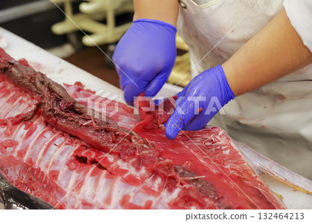 A craftsman cutting the tuna at a tuna cutting show A craftsman cutting the tuna at a tuna cutting show 132464213