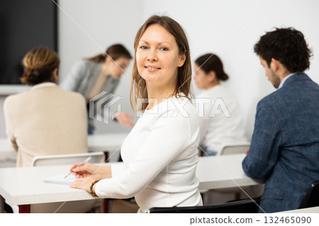 Portrait of successful business woman smiling at camera during symposium on business and entrepreneurship Portrait of successful business woman smiling at camera during symposium on business and entrepreneurship 132465090