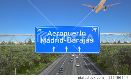Blue motorway sign for Madrid Barajas Airport with an airliner flying above along the road toward the airport. 3D rendering 132466544