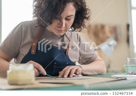 Woman tanner at work in the workshop.  132467334