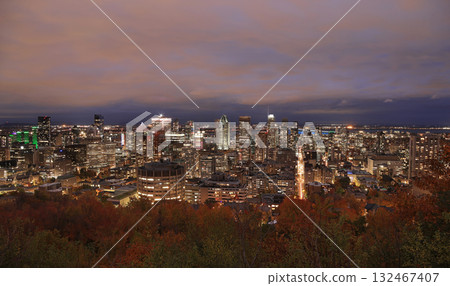 Aerial Montreal skyline illuminated at dusk with autumn colors and Saint Lawrence River on on the background, Canada 132467407