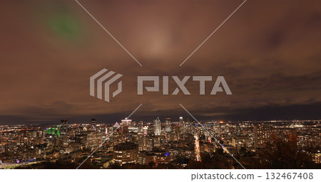 Aerial Montreal skyline illuminated at night with autumn colors and famous C 2025 A6 comet (Lemmon) on the sky, green, Canada 132467408