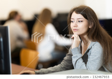 Portrait of female student studying in university computer class Portrait of female student studying in university computer class 132467933