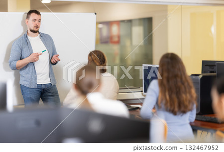 Young man giving presentation in office Young man giving presentation in office 132467952