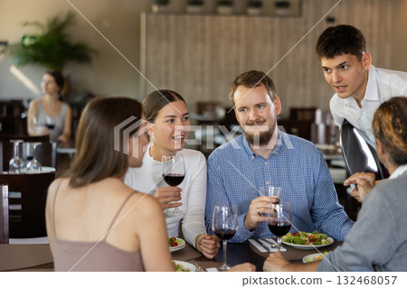 Waiter takes order from couple of men and women 132468057